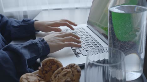 close up footage, caucasian female hands typing on laptop, side view