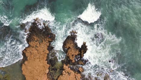 waves crashing by the seashore on stormy day aerial drone view of wild beach in the coastline of spain