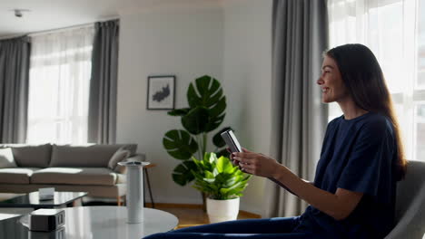 modern living room with woman using phone