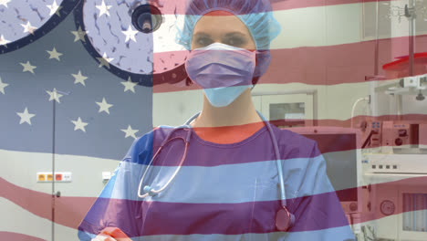 animation of flag of usa waving over female surgeon in operating theatre