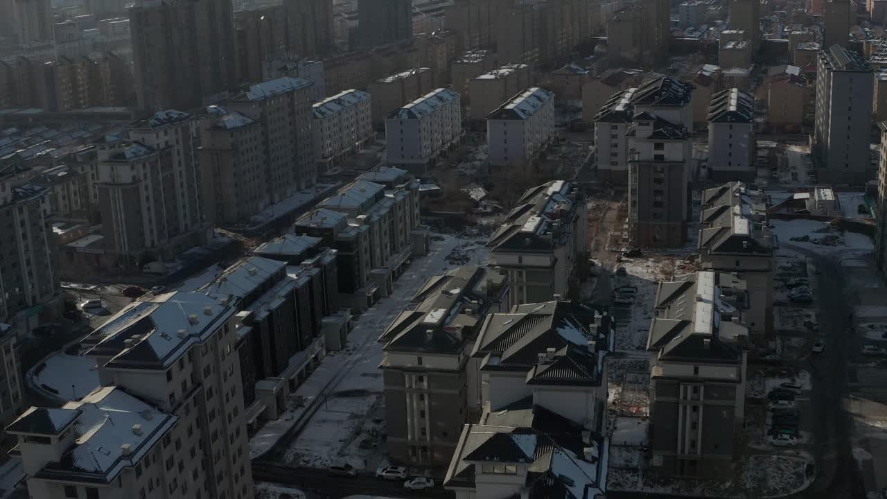Aerial tilting up shot to reveal rows and rows of identical Eastern Bloc housing in Communist state. 4K