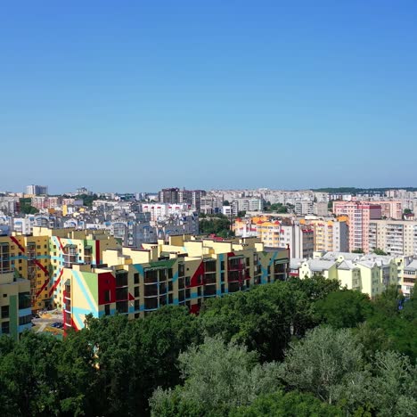 colorful residential complex in the city. flight over green trees on the urban background. contemporary part of a city. aerial view