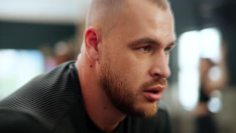man concentrated on workout in gym
