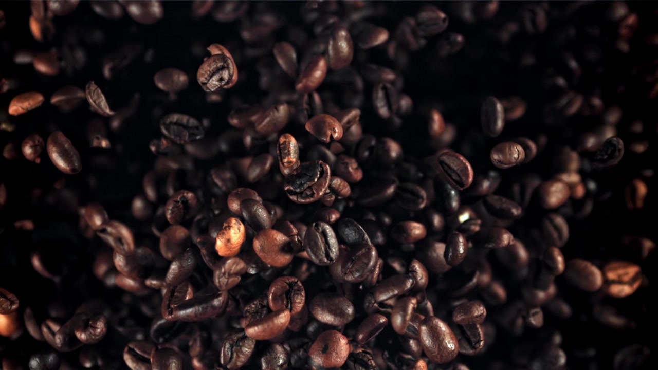 Roasted Coffee Beans Falling in Super Slow Motion on Dark Background