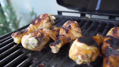 chicken drummies sizzling on the barbecue grill with a golden crispy skin