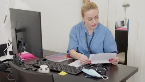 female doctor reading papers in office