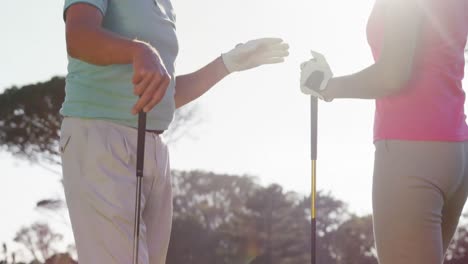 Two-happy-golfers-giving-high-five