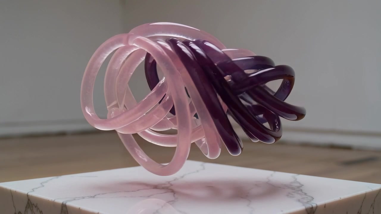 Starting clip causing floating linked rings rotating, shifting teal-to-purple above marble plinth