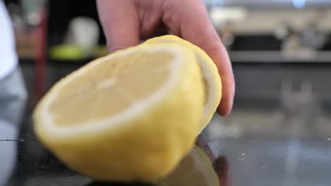 Close-up-as-a-chef-slices-a-lemon-in-half