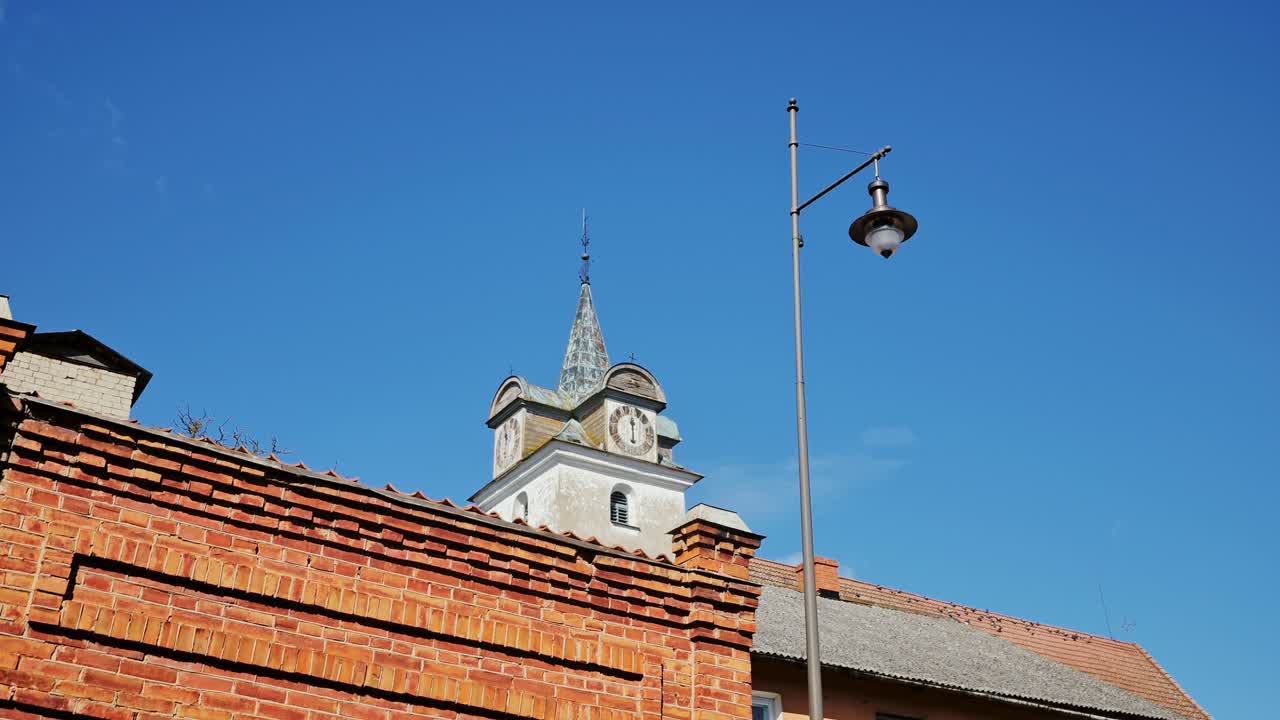 Kuldīga tower, bricks against blue sky evoke timeless charm and Baltic heritage