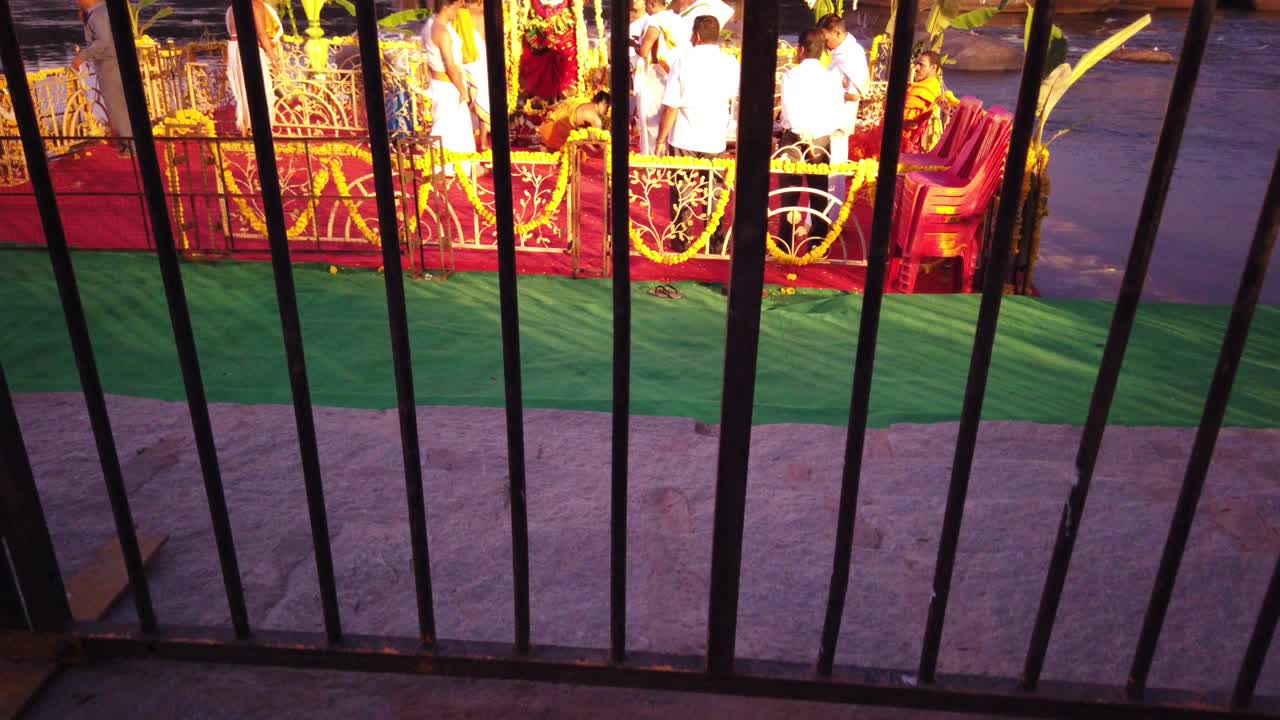 Vertical Dolly Shot of Priests Preparing Stage for Hampi Water Festival at Karnataka, India
