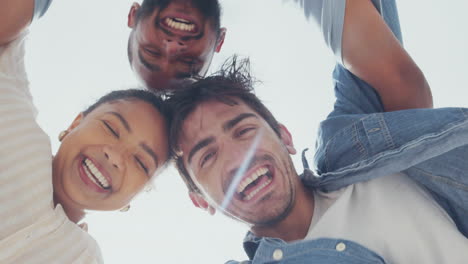 face, laughing and friends in a huddle from below