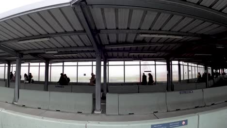 People-walking-at-the-open-air-airport-terminal-after-landing-at-the-Brussels-International-Airport-in-Zaventem,-Belgium