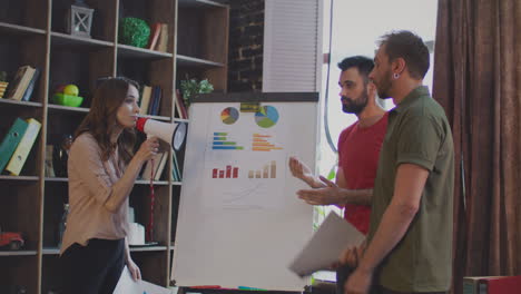 Business-conflict-in-office.-Female-boss-shouting-in-megaphone-on-sales-team