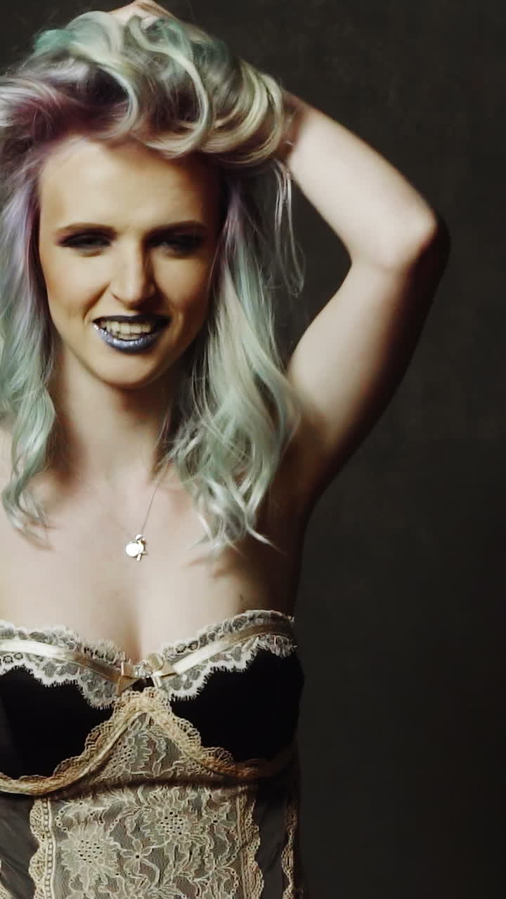 Playful woman in studio. Playful beautiful woman in black studio, portrait