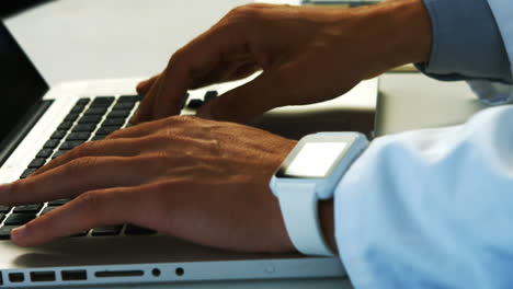 Scientist-using-laptop-in-laboratory