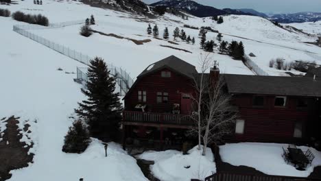 ariel views overlooking a log home during the winter