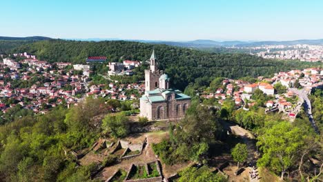 close-up drone orbit around church atop tsarevets fortress in veliko tarnovo, revealing medieval detail and spiritual heritage.