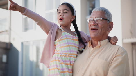 Happy,-pointing-and-girl-child-with-grandfather