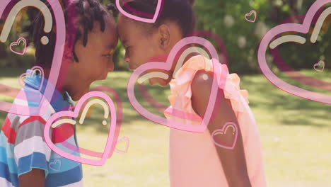 children laughing together with pink heart animation overlay in garden