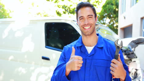 repairman with tools and thumbs up