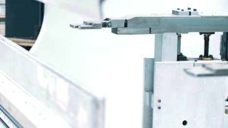 mechanism for holding metal plates on automated line. robotic unit