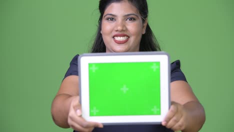 joven sobrepeso hermosa mujer de negocios india contra fondo verde