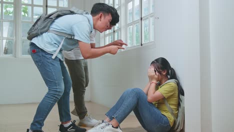 young asian students bullying caucasian girl in glasses