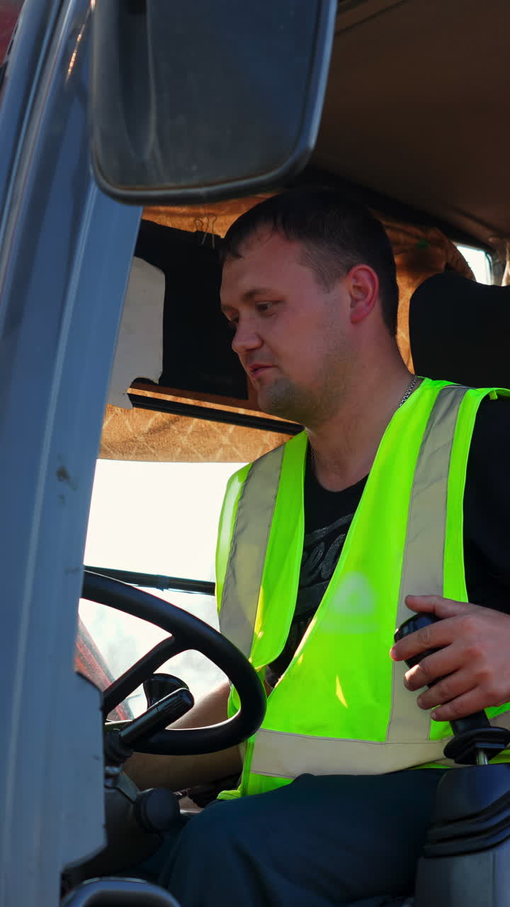 Man operating construction vehicle