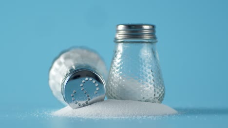 cans of salt slowly rotate on the table.