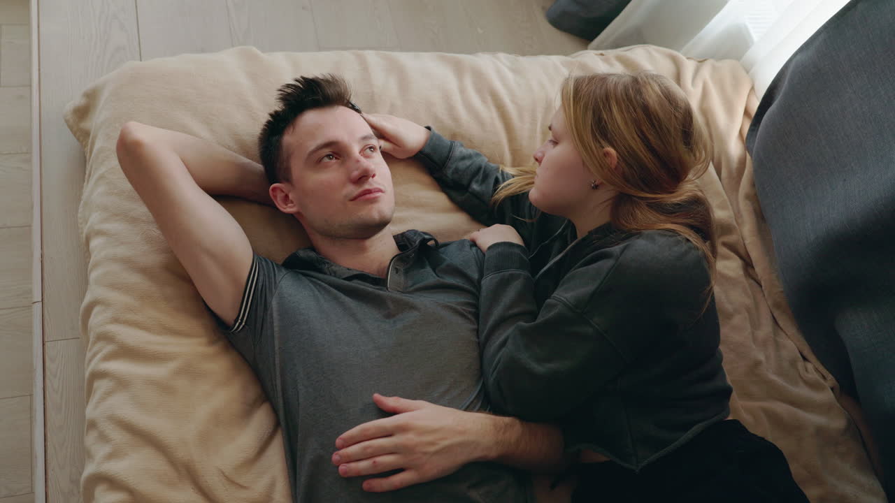 Couple Relaxing Together on a Bed