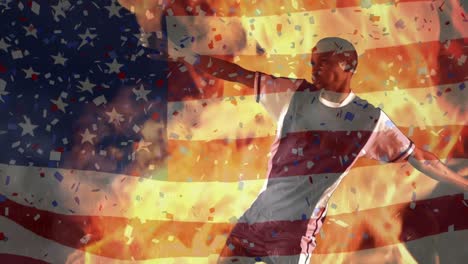 Animation-of-waving-usa-flag-and-falling-confetti-and-flames-over-football-player