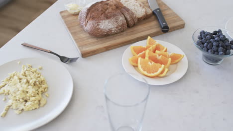 a breakfast spread is laid out on a marble countertop