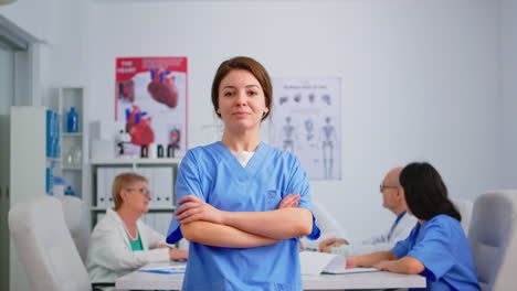 Portrait-of-young-nurse-standing-in-front-of-camera-smiling