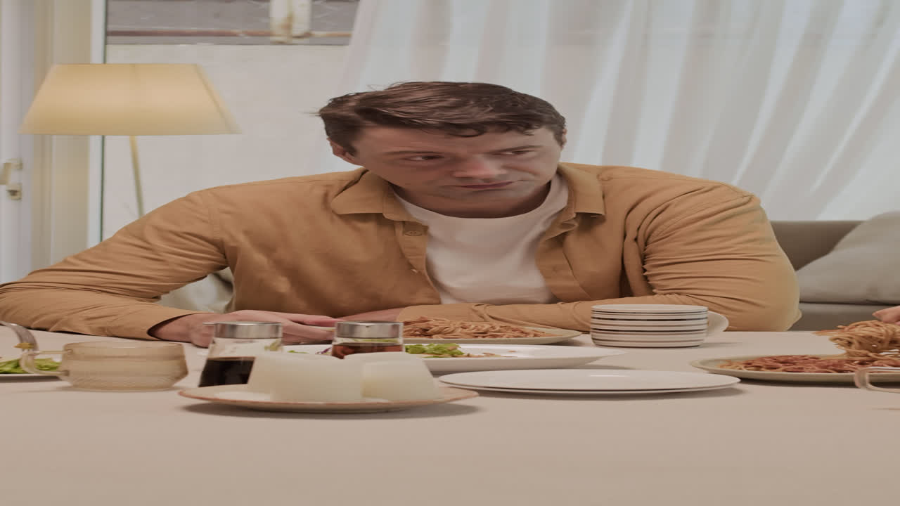 Caucasian Man Talking to His Family during Home Dinner