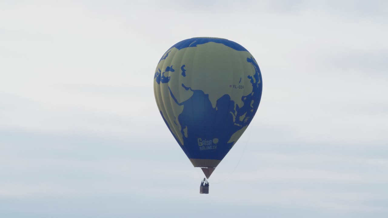 Hot air balloon low flight over autumn fall trees