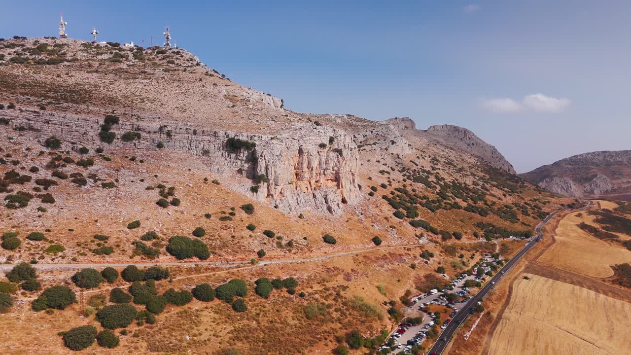 Aerial view of mountain cliff above valley road