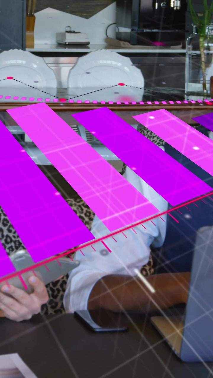 Vertical video: Tablet tap showing pink AR grid, woman swiping as partner using laptop for work