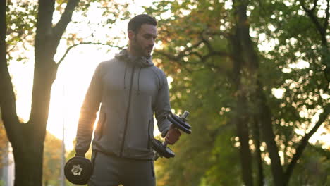 man working out with dumbbells in a park
