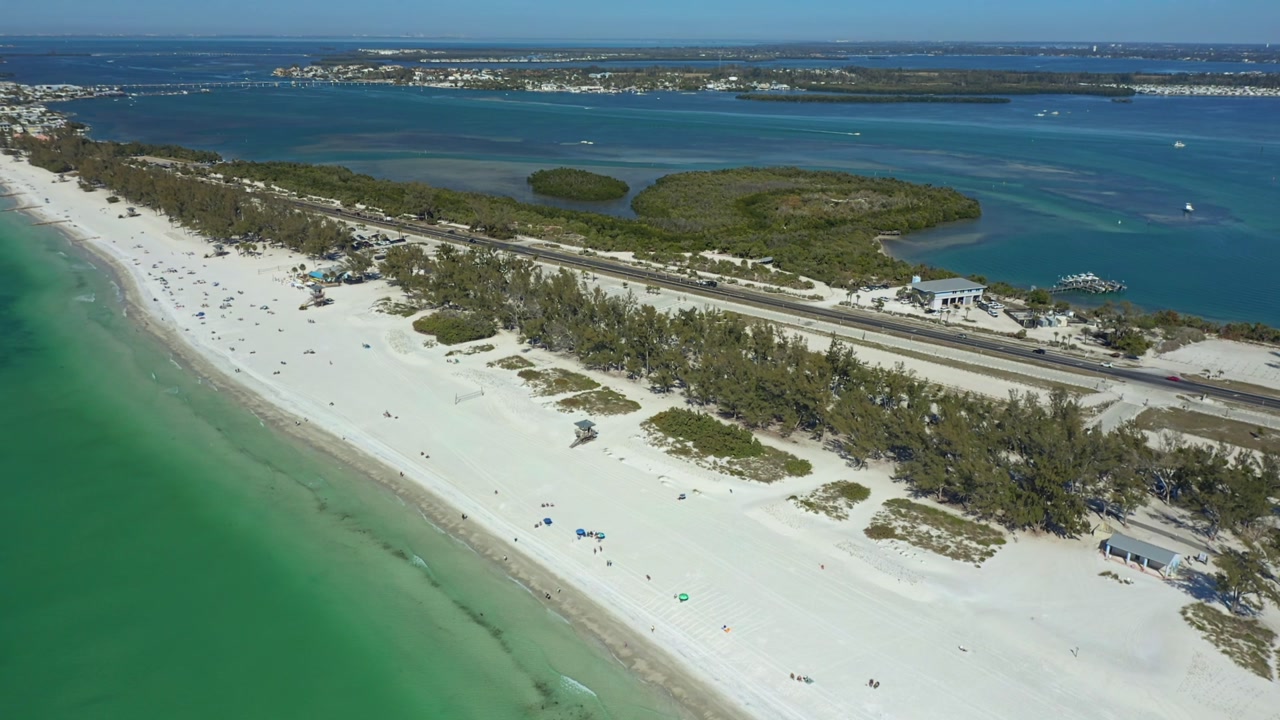 Pristine white sands stretch along the vibrant turquoise waters of Bradenton Beach.