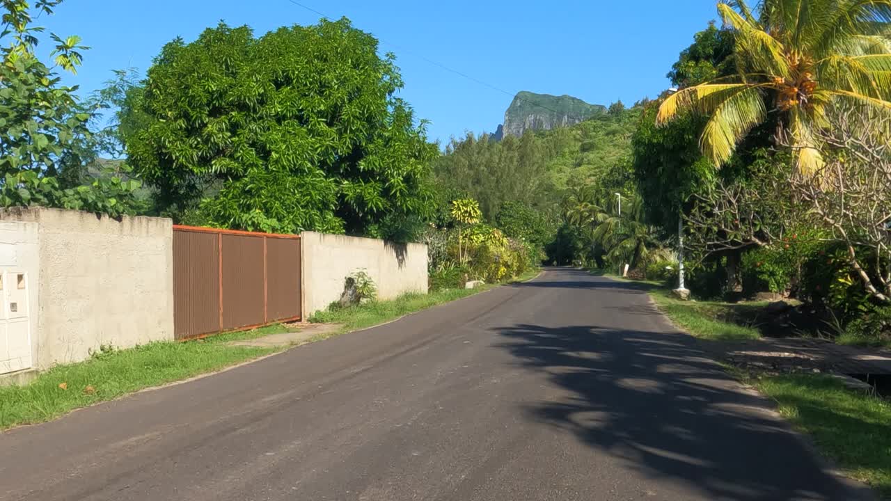 Driving on Road in Coastal Village of Bora Bora Island, French Polynesia, Houses and Landscape, Point of View