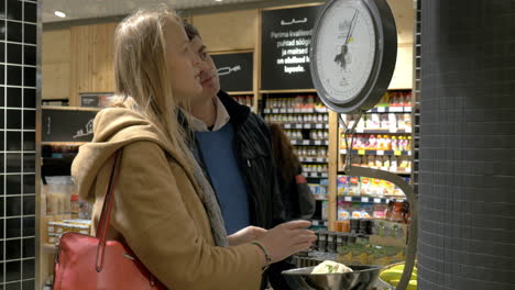 man and woman weighing cabbage