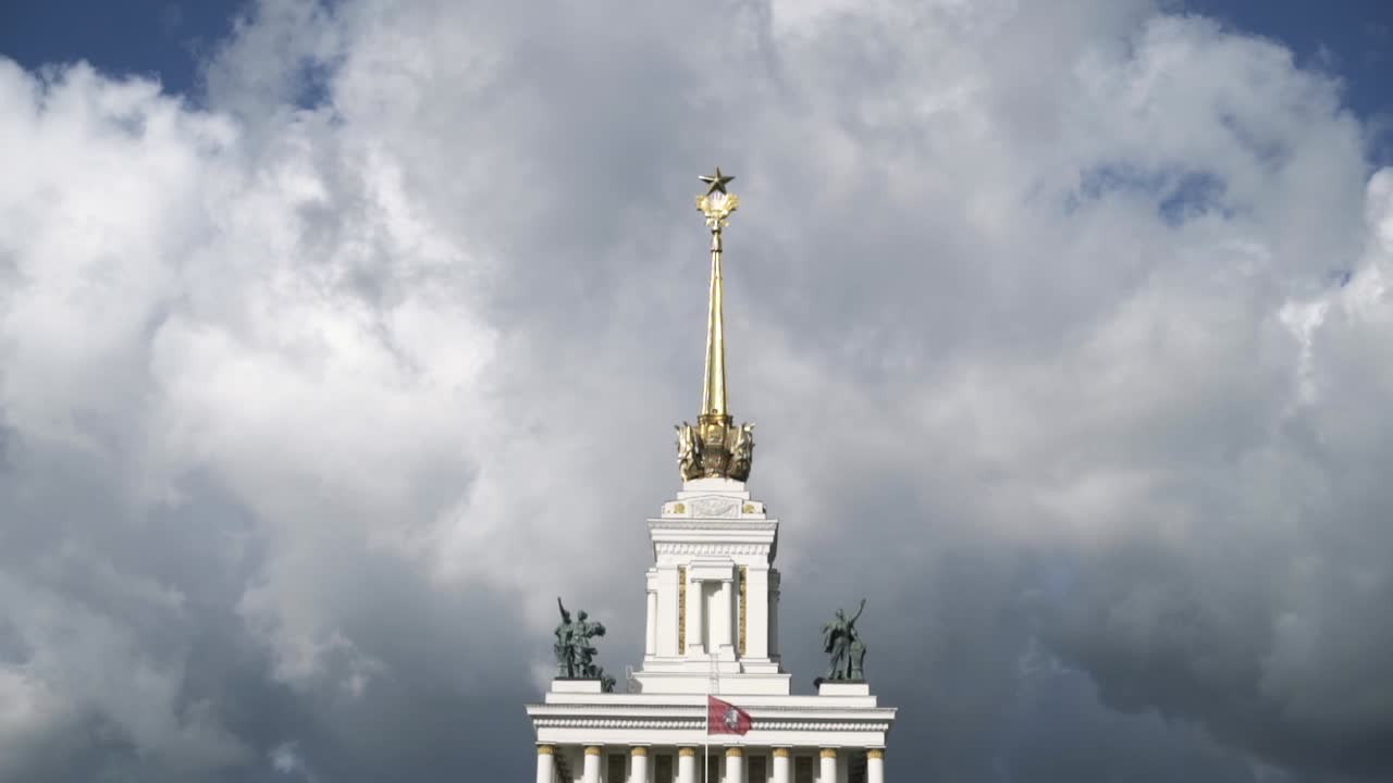 edificio de la era soviética con aguja ornamentada y cielo nublado