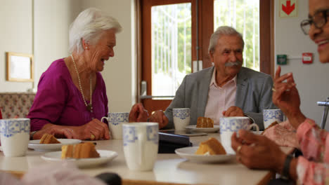 group of mixed-race senior friends eating breakfast on dining table 4k