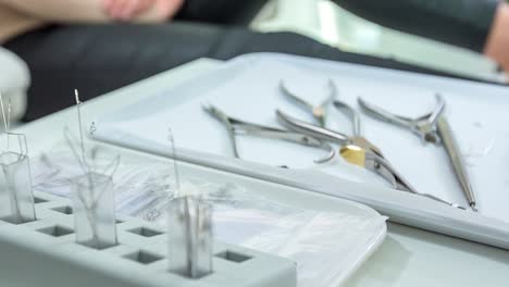 surgical instruments required for medical pedicure lying in the tray beside the patient