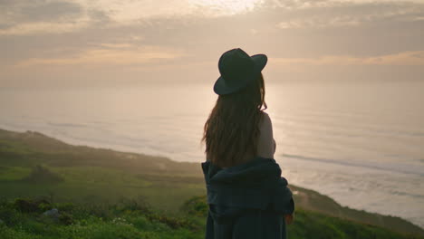 silhouette young girl posing at picturesque autumn sunset. woman standing nature