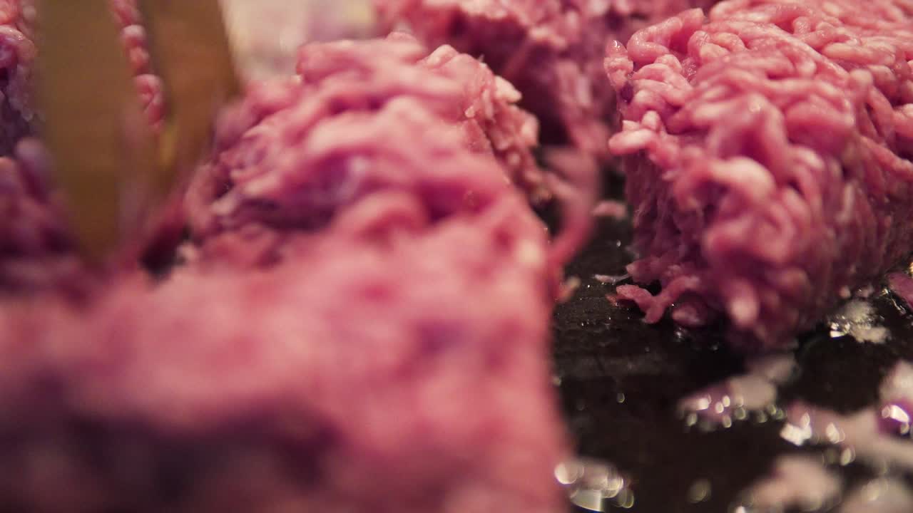 close up of minced meat being added into pan for cooking