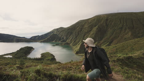 man in hat and sunglasses hikes on seaside hills at azores, close view