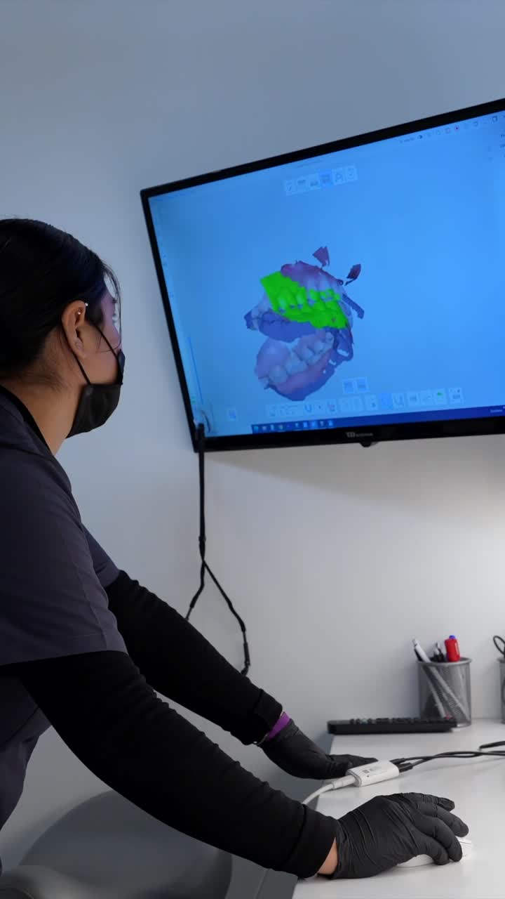 Dentist working with dental scan on computer