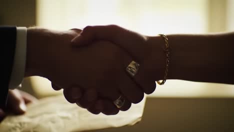 a moment of connection: two hands engaging with a document, symbolizing agreement and understanding in a softly lit space